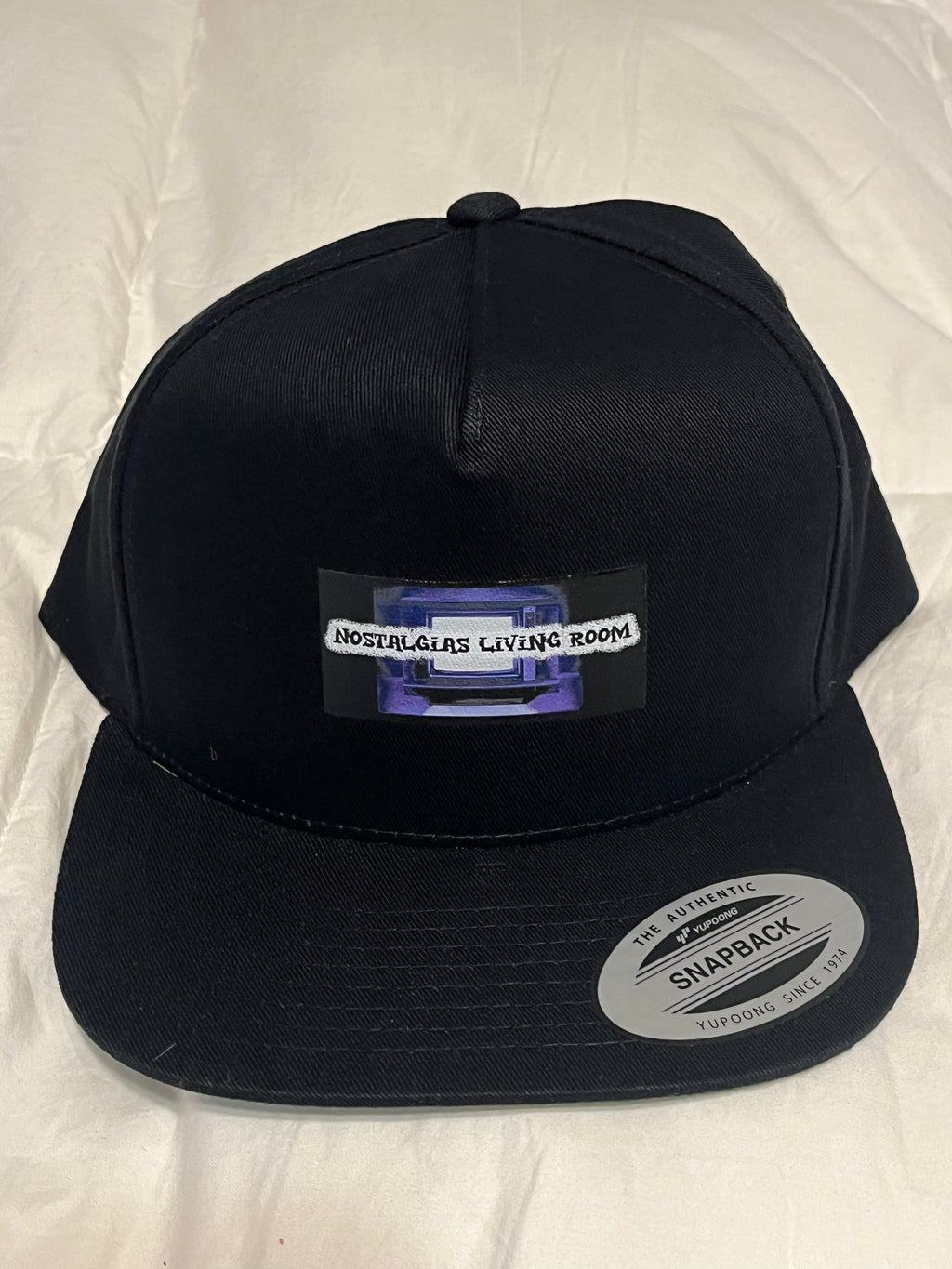 Nostalgias Living Room (1st Generation _ Black- Snap Back Hat)
